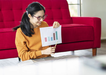 Woman sitting on chair at home