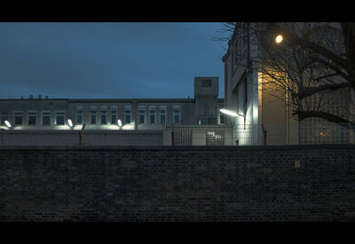 Illuminated building against sky at night