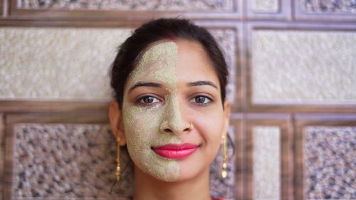 Spa woman with one side facial mask and fresh cucumber on eyes, relaxing at home. skin care, beauty