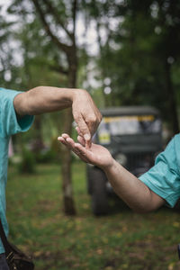 Midsection of man holding hands outdoor activity 