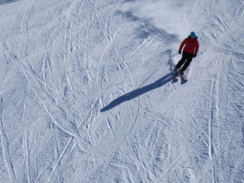 High angle view of person skiing downhill on snow