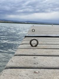 Surface level of pier over sea against sky