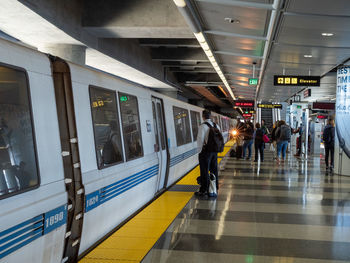 People walking on railroad station platform