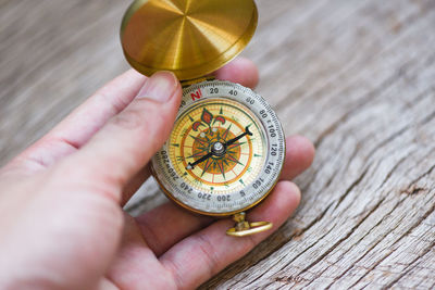 Cropped hand holding navigational compass