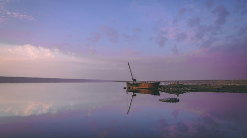 Scenic view of lake against sky during sunset