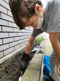 High angle view of girl standing against wall