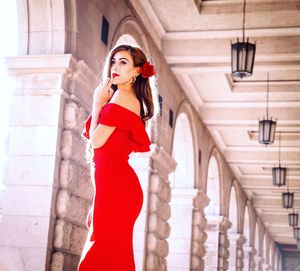 Side view of woman standing in corridor