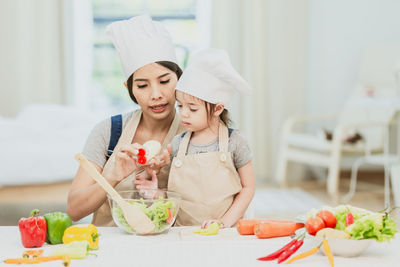 Portrait of woman with ice cream in kitchen