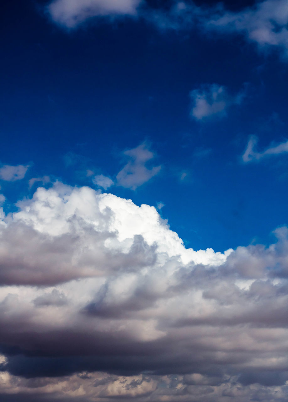 sky, cloud, blue, cloudscape, environment, beauty in nature, nature, dramatic sky, scenics - nature, daytime, atmosphere, backgrounds, overcast, no people, idyllic, tranquility, outdoors, sunlight, fluffy, wind, white, storm cloud, horizon, day, meteorology, storm, religion, high up, landscape, light - natural phenomenon, tranquil scene, spirituality, space, awe, summer, moody sky