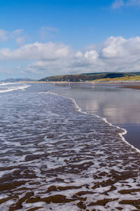 Scenic view of sea shore against sky