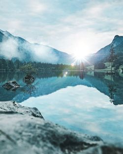 Scenic view of lake and mountains against sky