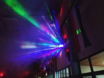 Low angle view of illuminated stage at night