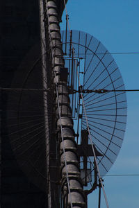 Low angle view of cables against clear blue sky