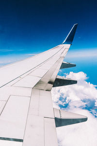 Airplane wing against blue sky