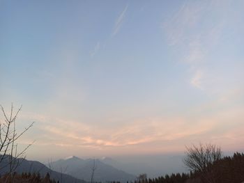 Low angle view of silhouette mountains against sky at sunset