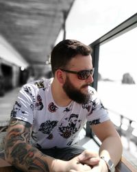 Young man looking through window while sitting in boat