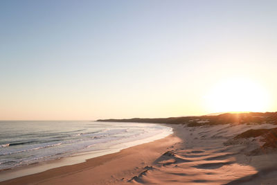 Scenic view of sea against clear sky during sunset