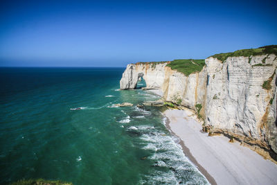 Scenic view of sea against clear blue sky