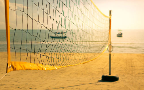 Close-up of beach volleyball net on beach against sky