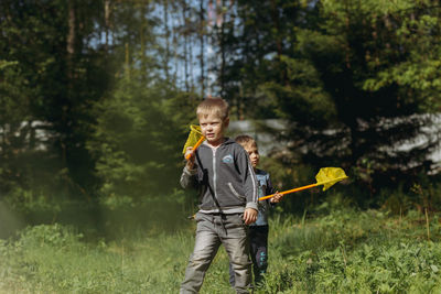 Little boys with butterfly nets in countryside. image with selective focus