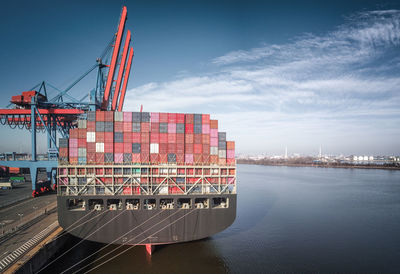 Commercial dock by sea against sky in city