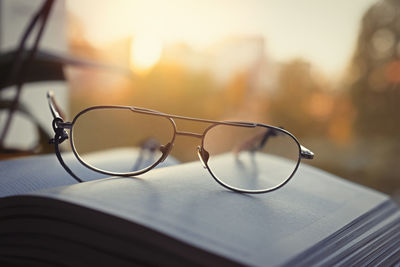 Close-up of a book with glasses on the background of the window. home rest concept