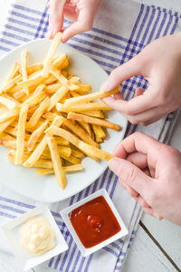Midsection of woman holding food on table