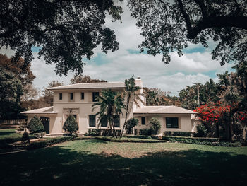 Lawn by building against sky