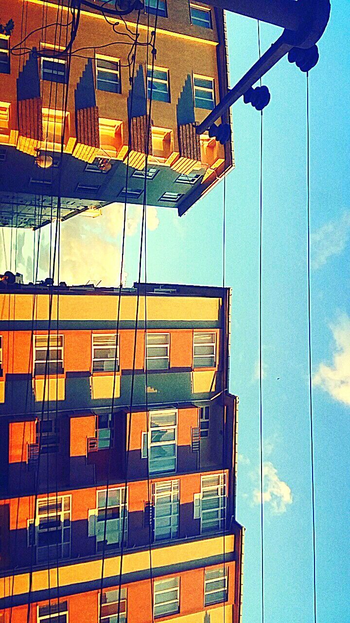 building exterior, architecture, built structure, low angle view, residential building, residential structure, multi colored, window, building, city, balcony, day, in a row, apartment, outdoors, no people, house, sky, yellow, clear sky