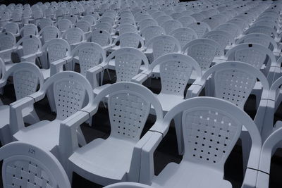 Empty white chairs in the square