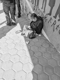Woman standing on footpath