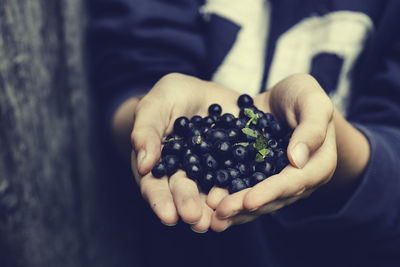 Close-up of child hand with blueberrys