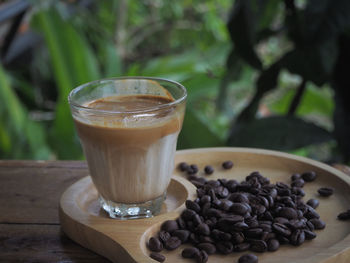 Close-up of coffee beans in glass on table