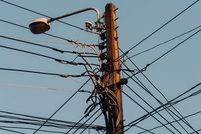 Low angle view of electricity pylon against sky