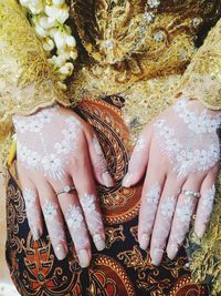 High angle view of woman holding hands in wedding traditional