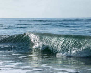 Wave in sea against sky