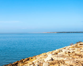 Scenic view of sea against blue sky