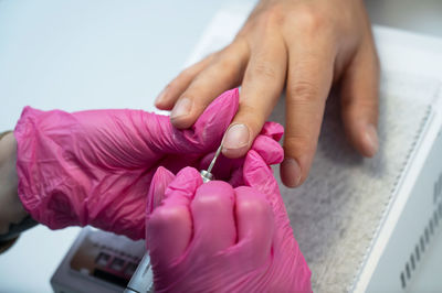 Cropped hands of woman holding dentures