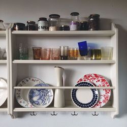 Plates and glass in shelves at home