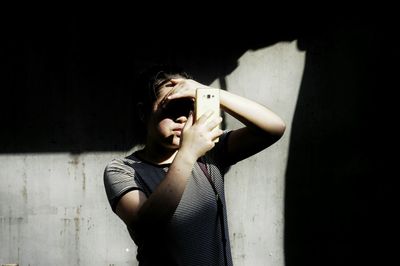 Woman looking away while standing on floor