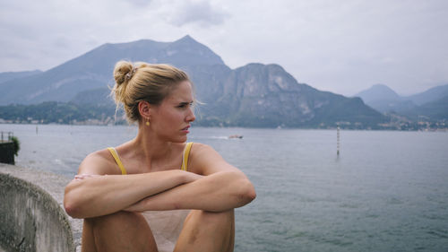 Portrait of young woman looking at lake