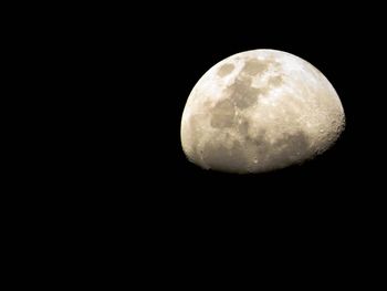 Low angle view of moon against clear sky at night