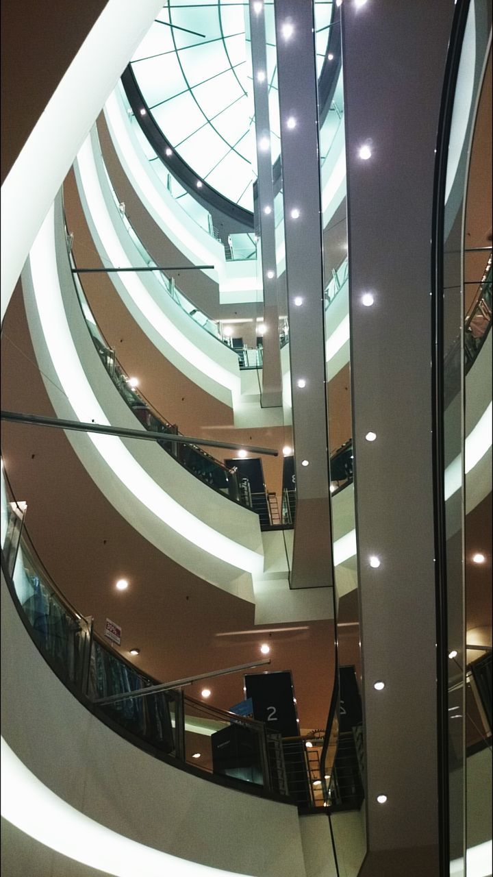 indoors, architecture, built structure, railing, modern, ceiling, steps and staircases, staircase, steps, diminishing perspective, in a row, escalator, high angle view, repetition, transportation, building, low angle view, architectural feature, no people, pattern