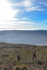 People on land against sky