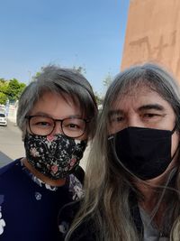 Portrait of mature couple against sky