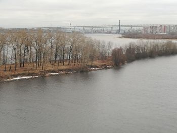 Scenic view of river against sky during winter