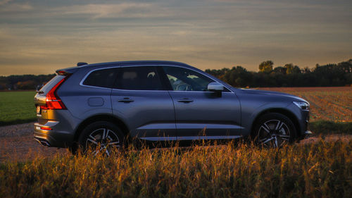 View of car on field during sunset