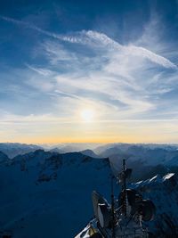 Scenic view of snowcapped mountains against sky during sunset