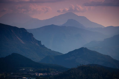 Scenic view of mountains against sky at sunset