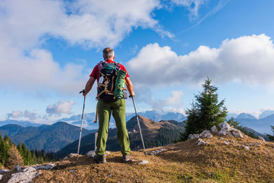 Man standing on mountain against sky